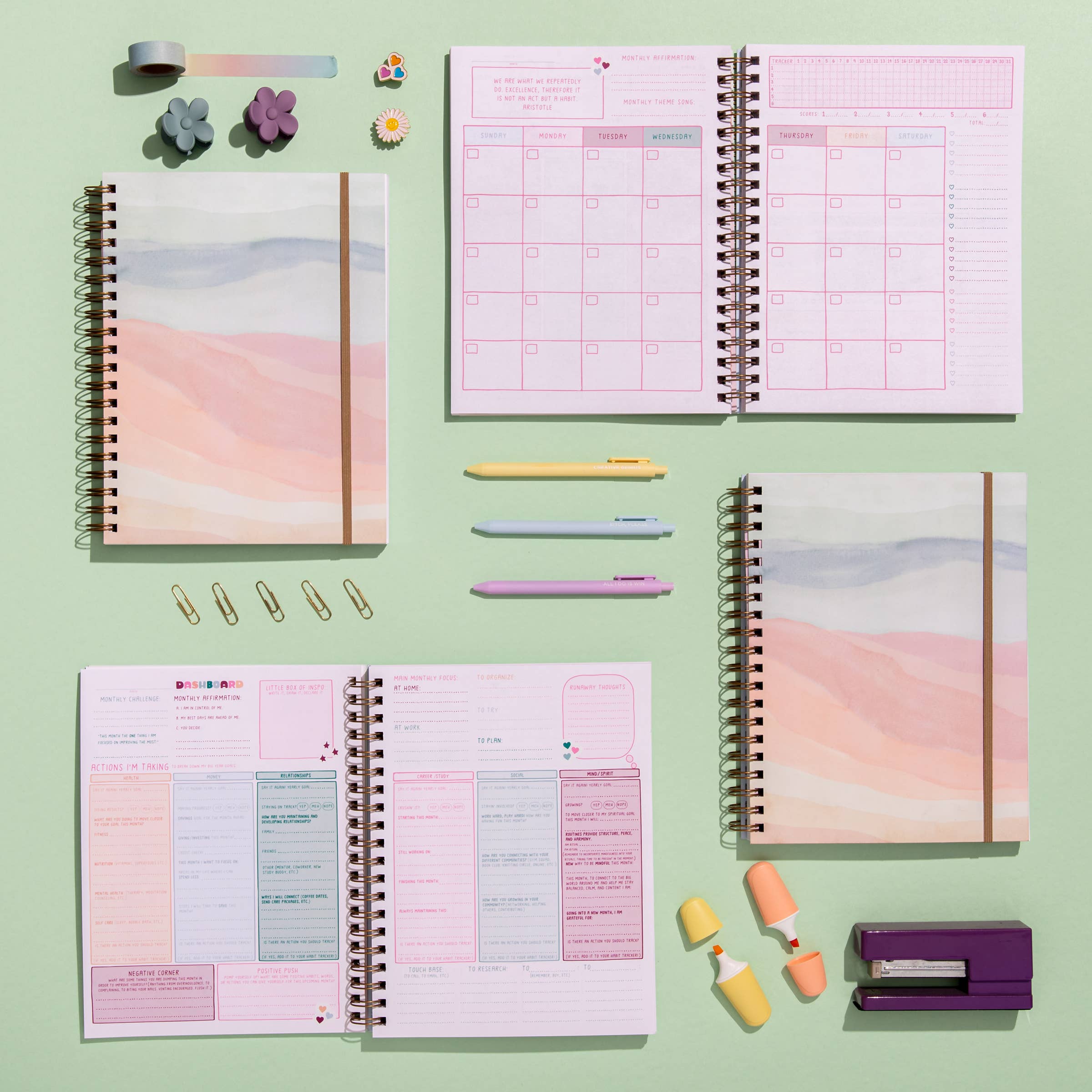 Planners with colorful stationery items on a green background
