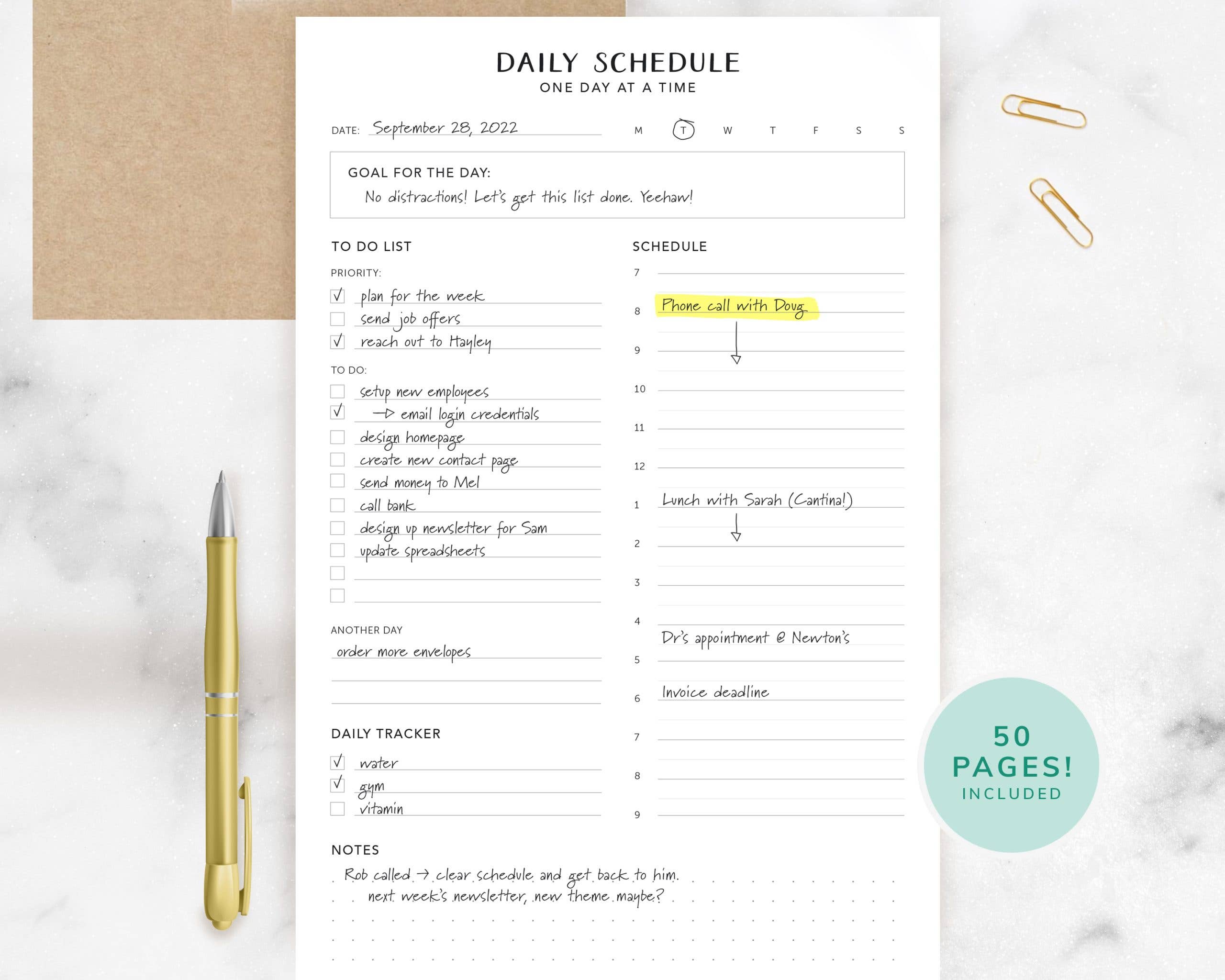Daily schedule planner with a pen on a marble surface