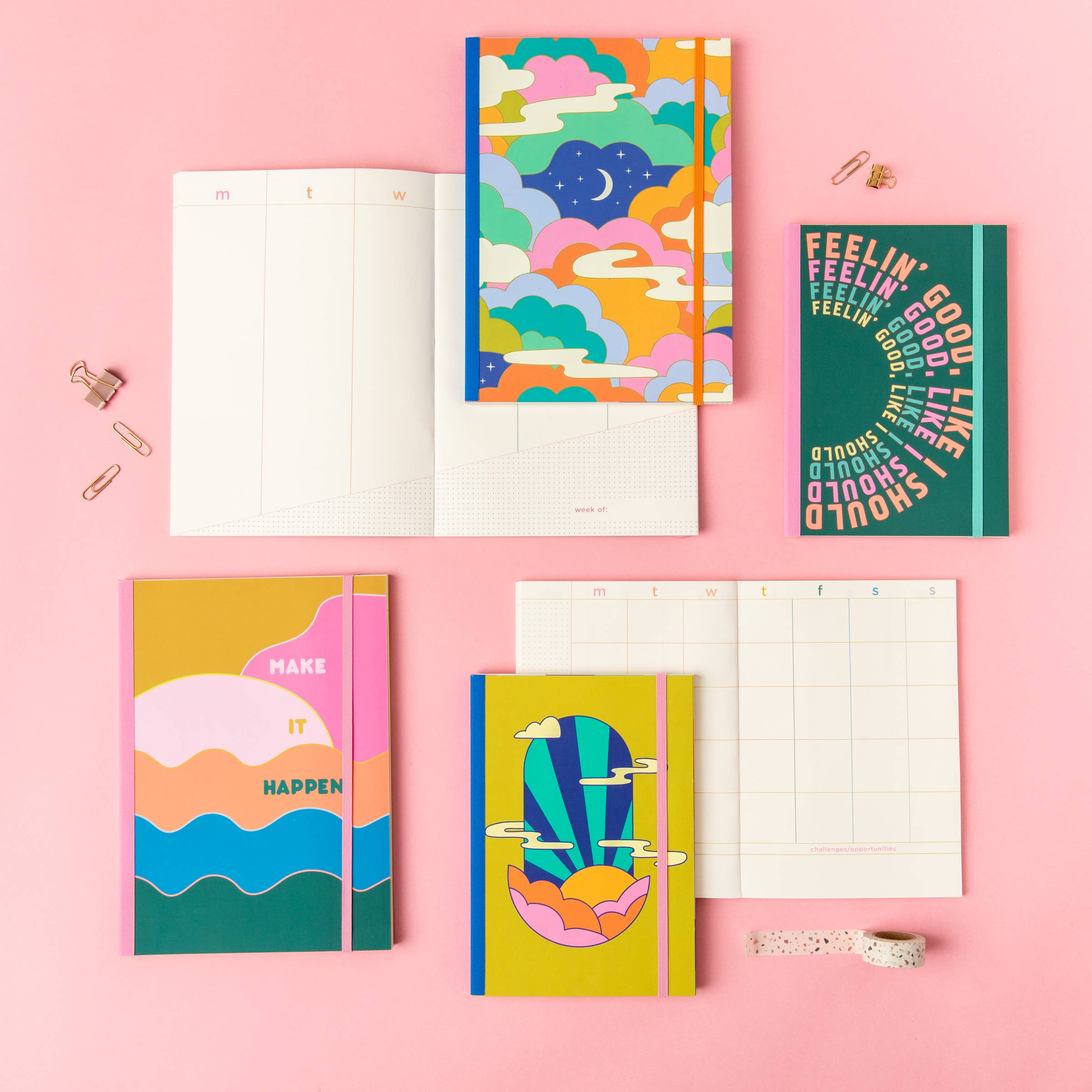 Colorful planners and journals on a pink background