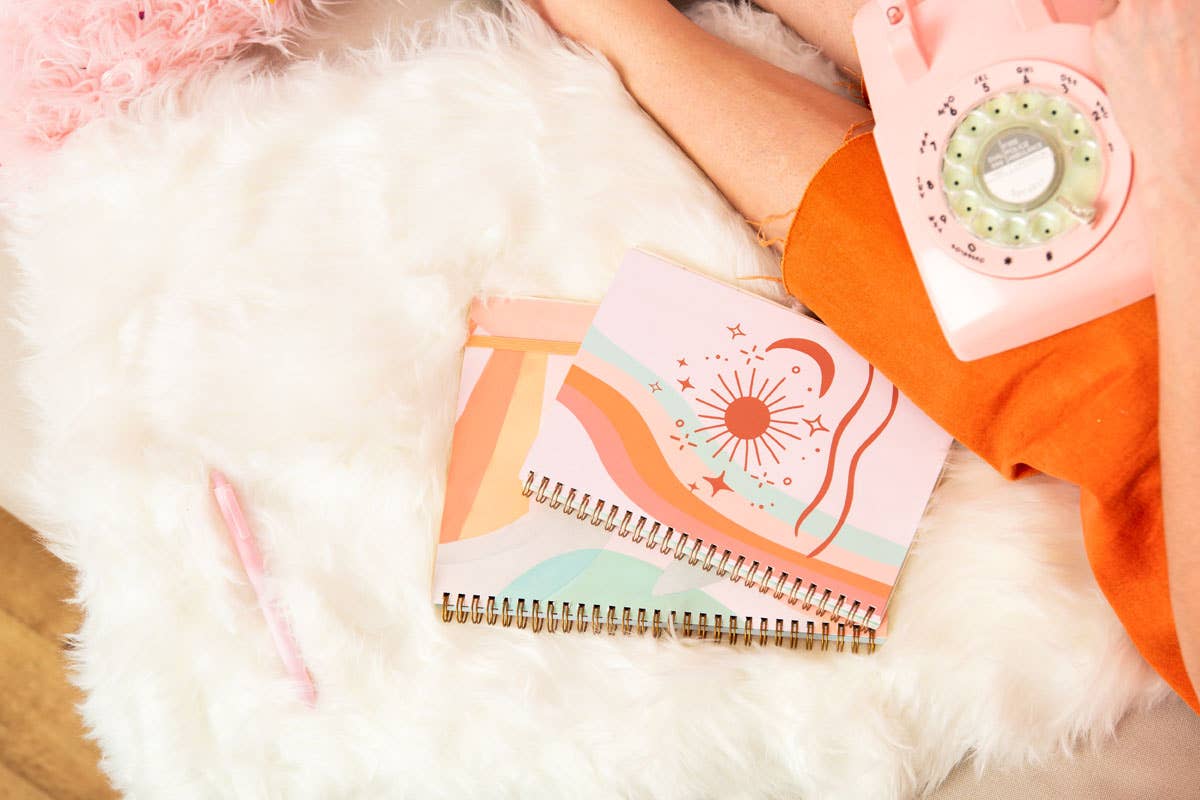 Notebook with colorful design on a fluffy white surface