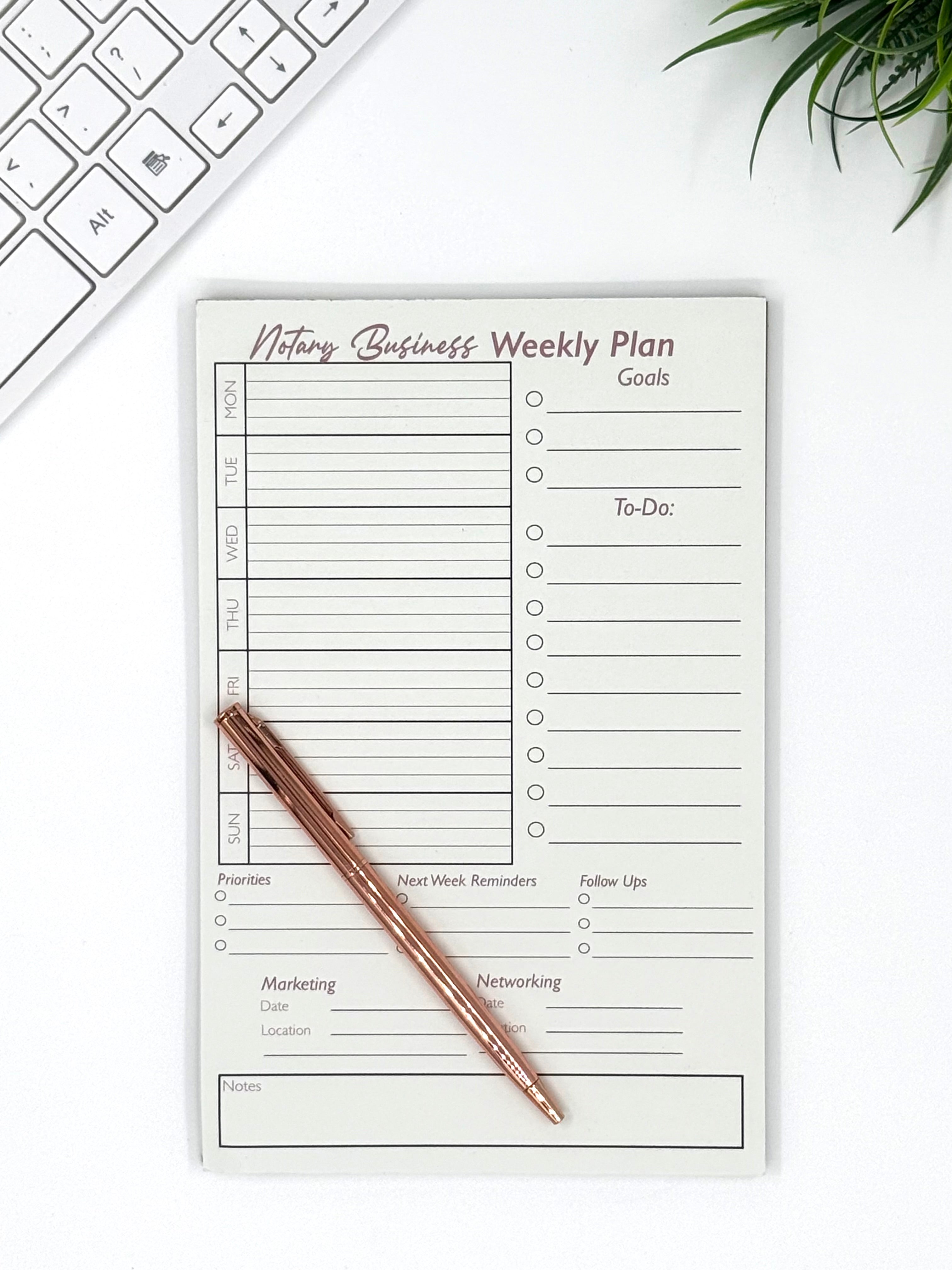 Notary business weekly plan pad with a pen on a white surface