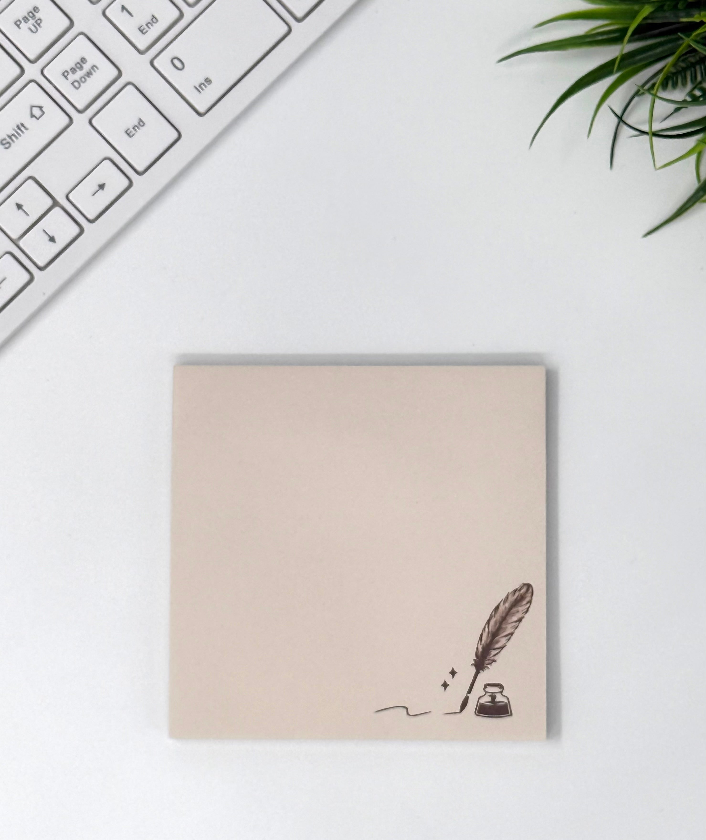 Beige sticky note pad with quill and ink bottle illustration